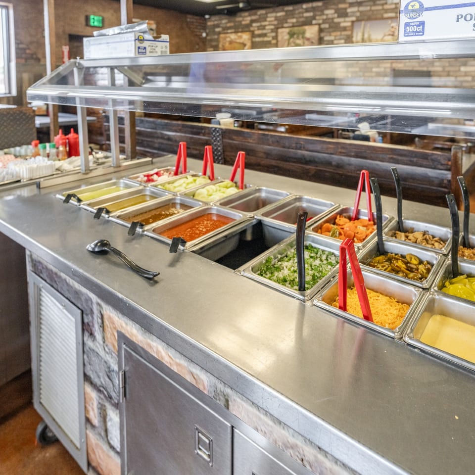 Salsa bar with sauces and toppings